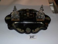 A Victorian black lacquer and mother of pearl inlaid desk stand (inkwell a/f)