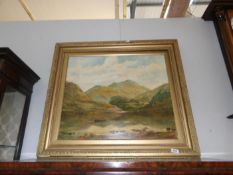 A gilt framed oil on board mountain and lake scene singed P Creighton