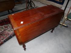 A mahogany drop leaf table