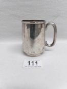 A silver christening mug with engraving, H M London 1920,