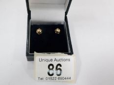 A pair of 9ct gold ear studs