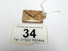 A 9ct gold stamp case shaped as an envelope,