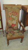 A mahogany framed chair with tapestry seat and back