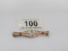 A 10k gold bar brooch set aquamarine and rubies