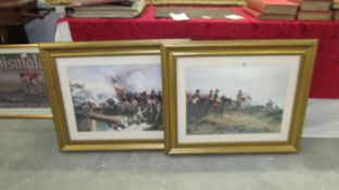 A pair of framed and glazed battle scenes