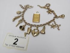 A gold charm bracelet and a 5g gold ingot