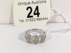 An 18ct white gold 82pt diamond baguette and brilliants ring,