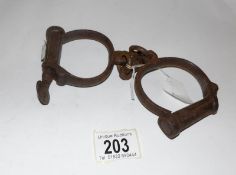 A pair of Victorian police hand cuffs with key