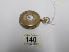 A gold filled half hunter pocket watch with enamel dial (missing glass)