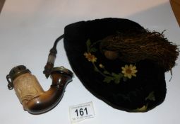 An ornate pipe and an embroidered smoker's cap