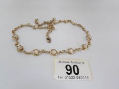 A gold necklace set with seven split pearls in a twisted link style, total weight approximately 20.