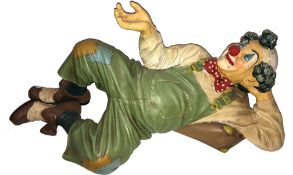A large figure of a reclining clown