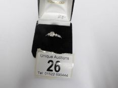 An 18ct white floral top and side shanked diamond ring,