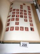 An old stamp album containing penny reds,