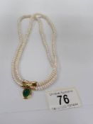 An 18ct gold and pearl necklace set with green gemstone and diamond clasp