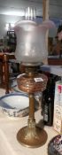 A oil lamp with brass base, brass column,