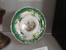 An early Coalport cabinet plate with pierced green and gilt border, hand painted landscape,