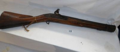 A late 18th century flintlock blunderbuss rifle with bronze barrel, named T Saunders,