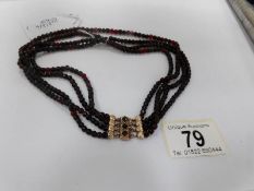 A Victorian 4 row garnet necklace with 9ct gold chased clasp