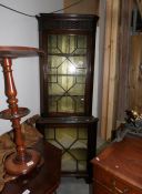 A corner cabinet with astragal glazed doors