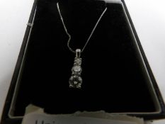 An 18ct platinum pendant on chain set with 3 diamonds