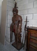 A full size suit of armour and a quantity of swords