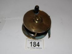 A vintage brass fishing reel