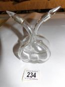 A silver topped oil/vinegar bottle