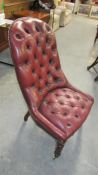 A Victorian red leather deep buttoned library chair