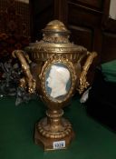 A 19th century metal urn with cameo inset