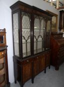 An early 20th century display cabinet with cock beaded glazed doors