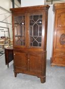 A 19th century oak corner cupboard (back leg a/f)