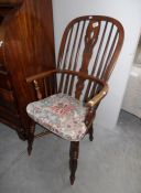 A Victorian Windsor chair with crinoline stretcher