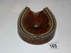 An unusual oak and brass horse shoe shaped crib board
