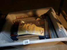 A crate of cigarette cards and albums (some empty)