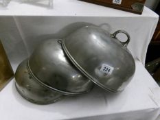 A set of 3 pewter food covers