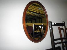 An oak framed bevel edged mirror