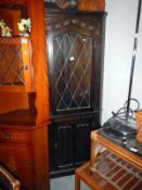 A corner cabinet with leaded glass door