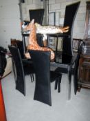 A black smoked glass dining table & 6 chairs