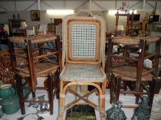 A wicker chair & 4 rush seated stools
