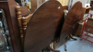 A mahogany double pedestal table with one extra leaf