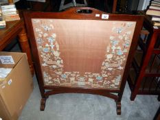 A fire screen with a Chinese silk panel