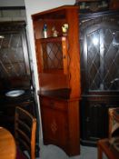 A corner display cabinet with leaded glass door