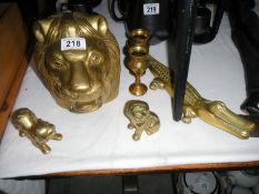 A quantity of brass items including crocodile nut cracker & large lions head etc.