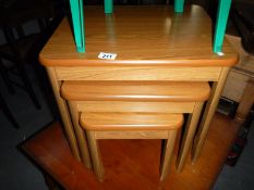 An Ashcraft teak effect nest of 3 tables