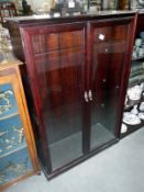 An etched glass door display cabinet