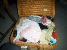 A wicker basket with miscellaneous clothes & handkerchiefs etc.