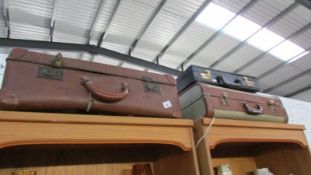 2 vintage suitcases and a briefcase