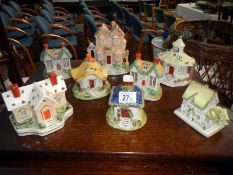 A collection of 8 various china cottages including Staffordshire money boxes,