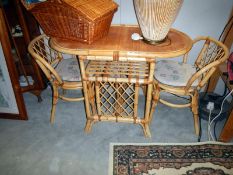 A wicker conservatory table & 2 chairs